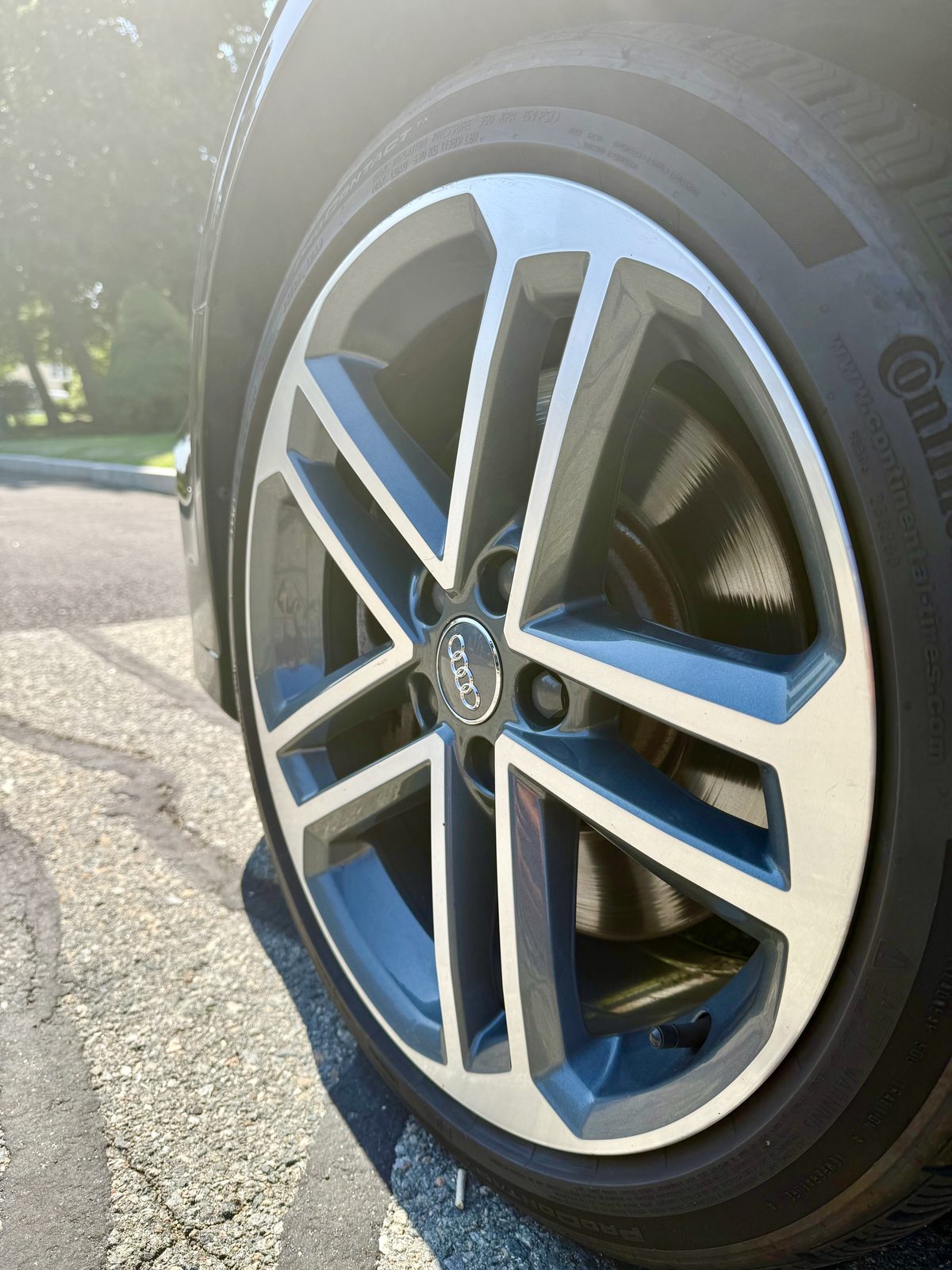Close-up of a clean Audi five-double-spoke machined alloy wheel with brake dust removed from the spokes and barrel